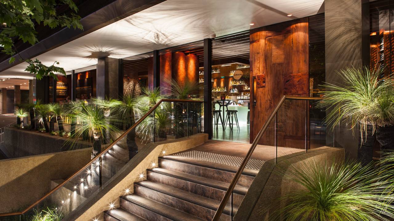 The lit exterior entrance to Grain Bar at Four Seasons Hotel Sydney